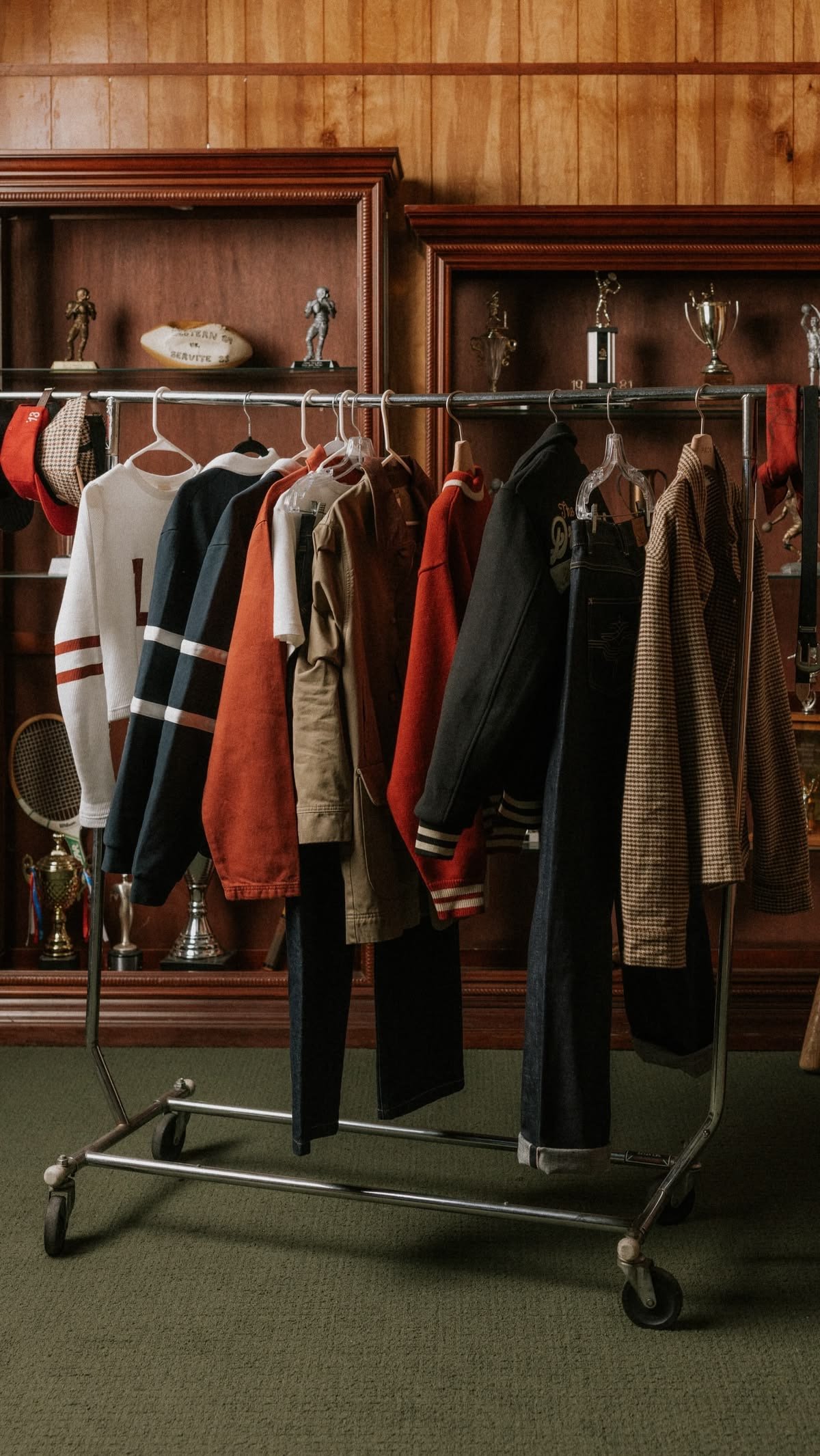 Printed blouses on wooden hangers along a clothes rail