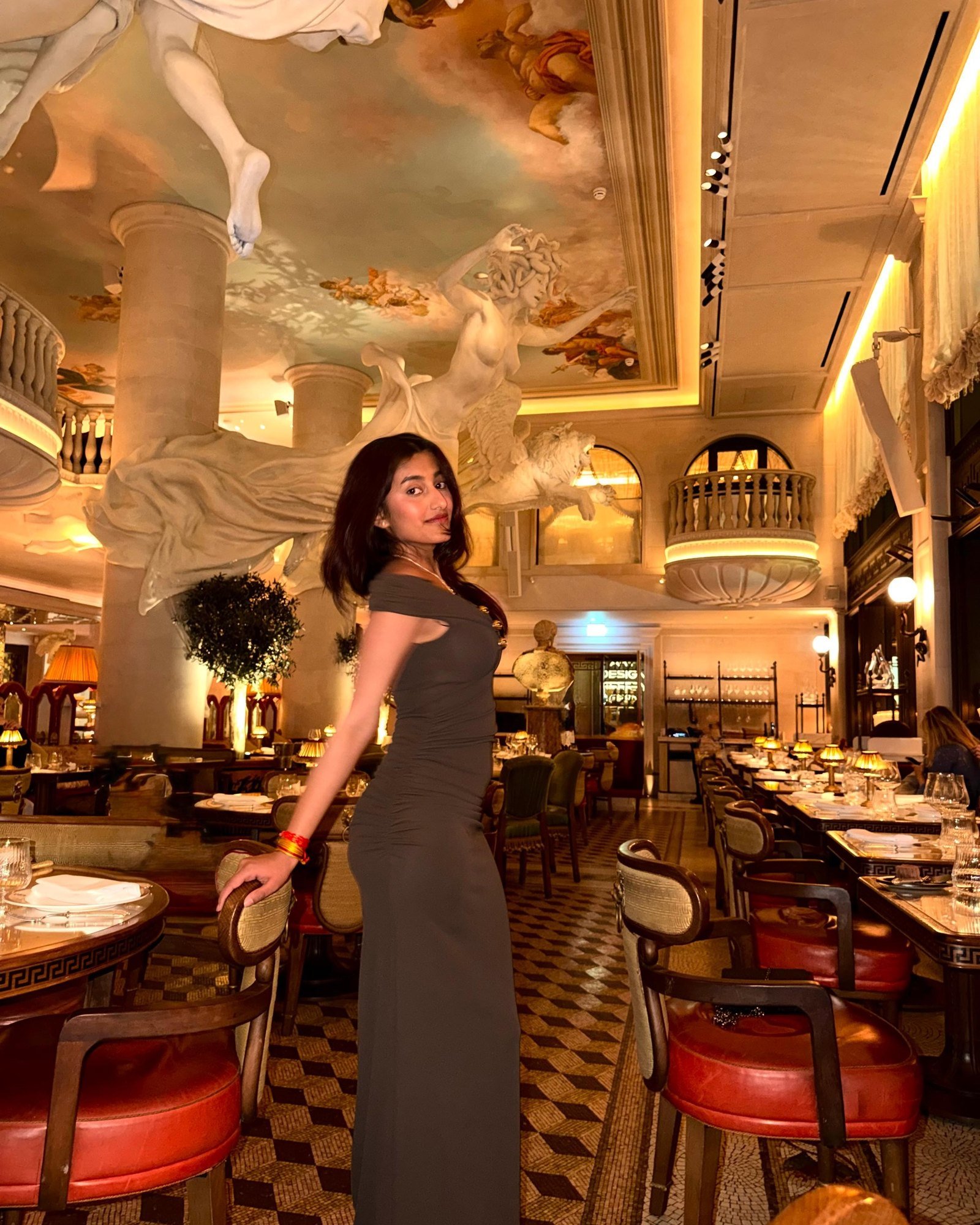Honey Jaiswal, founder of Splurge, in a grand painted dining room