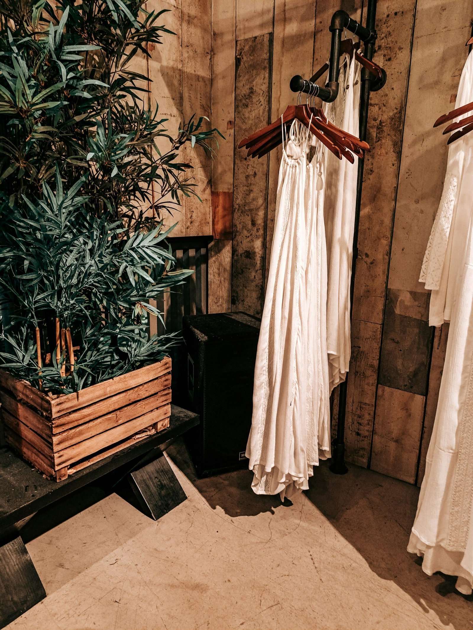 A rail of pale dresses in a quiet shop